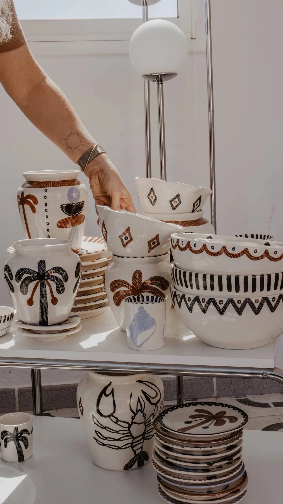 Anna Ciok ceramics arranged near a window