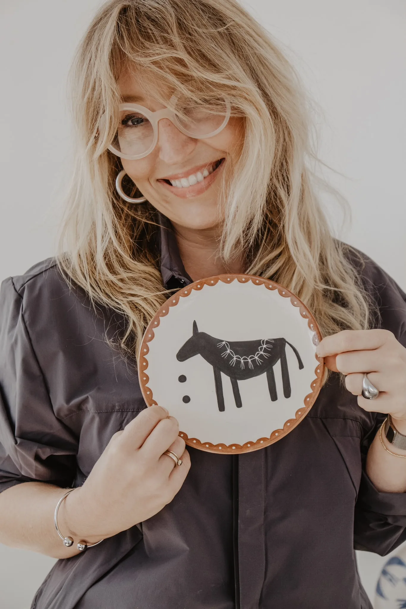 Anna Ciok holding a plate with a black eye motif